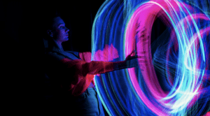medium_-_person_putting_hand_through_pink_and_blue_light_portal